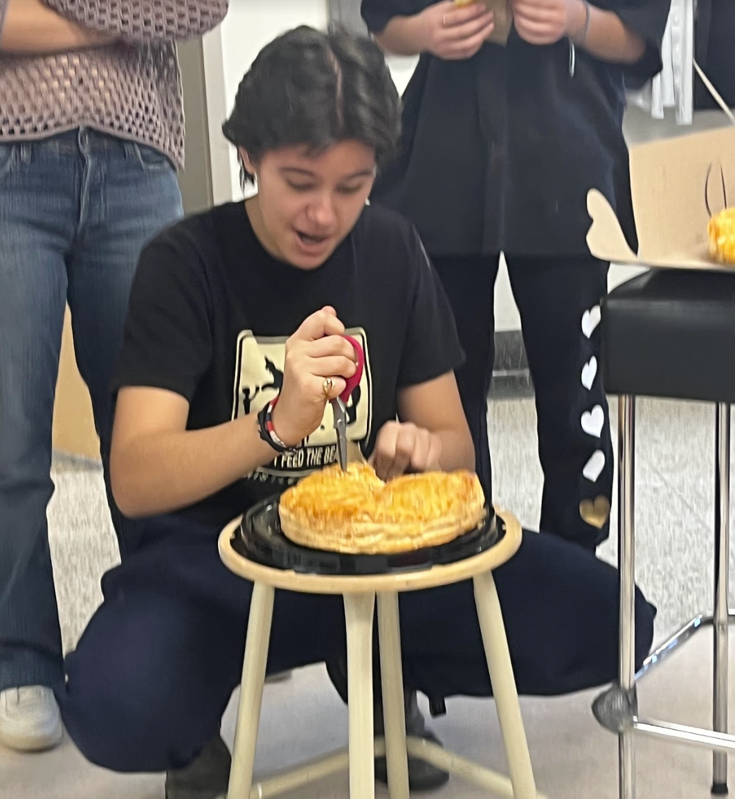 Isabella cutting a cake with scissors